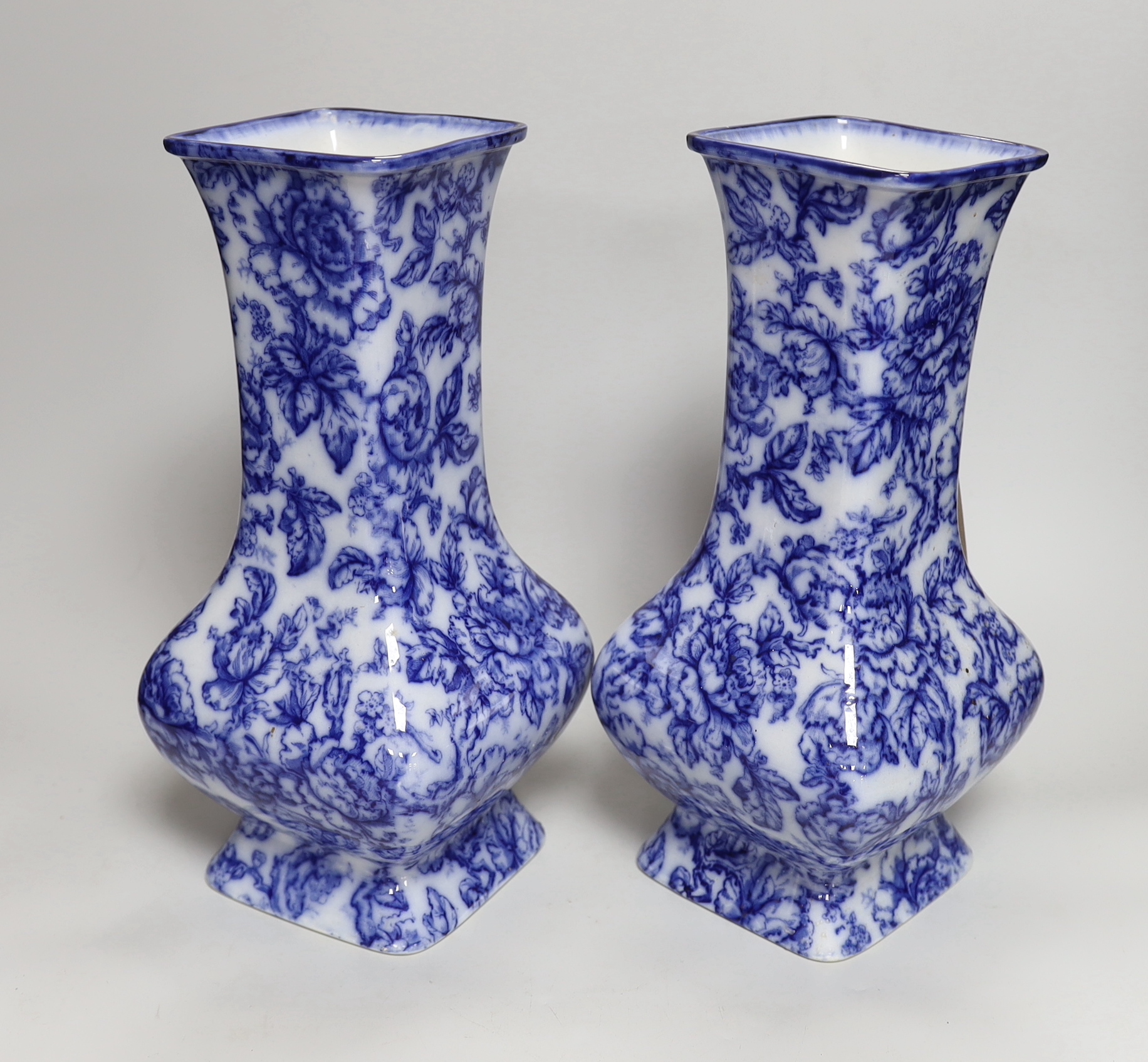 A pair of Losol ware blue and white vases, a slipware jug, a faience candle holder and a Chinese tea canister (without cover), vases 33cm high